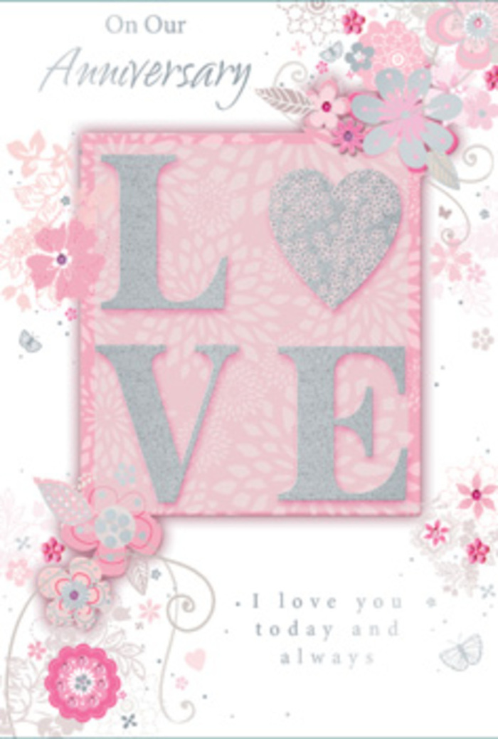 An exquisite anniversary card is pictured, its design unfolding like a delicate bouquet arranged on a calm morning in Hook. In the centre, the word LOVE appears in bold, uppercase letters, each one slightly raised from the surface so that the glitter-touched texture can be felt as much as seen. The glitter is soft and refined, a mix of pearly white and fine silver that catches the light in a gentle, romantic way, never harsh. Behind this word, a wash of blush pink forms a smooth backdrop, its tone reminiscent of pale rose petals just beginning to open. Extending from the edges of the central motif, wispy hand-drawn flowers and sprays of leaves drift outward, as though a pastel bouquet has been sketched directly onto the card. The blossoms, in delicate hues of blush, ivory, and hint of lilac, are outlined with precise, flowing lines and shaded with such subtlety that they almost seem to hover above the pink ground. Between them, filigree curls, dainty leaves, and tiny, almost hidden butterflies flutter like a soft breeze passing through a garden border near King Johns Road. Around and beneath the floral design, an anniversary message flows in a refined, gently looping script, expressing sentiments of enduring devotion and daily appreciation. The overall composition is light and airy, with plenty of breathing space so that each floral detail can be appreciated, much like the careful spacing of stems in a hand-tied bouquet crafted at Flower Delivery Hook. The atmosphere the card creates is one of quiet gratitude, long-term trust, and the serene joy of loving and being loved over many shared years.